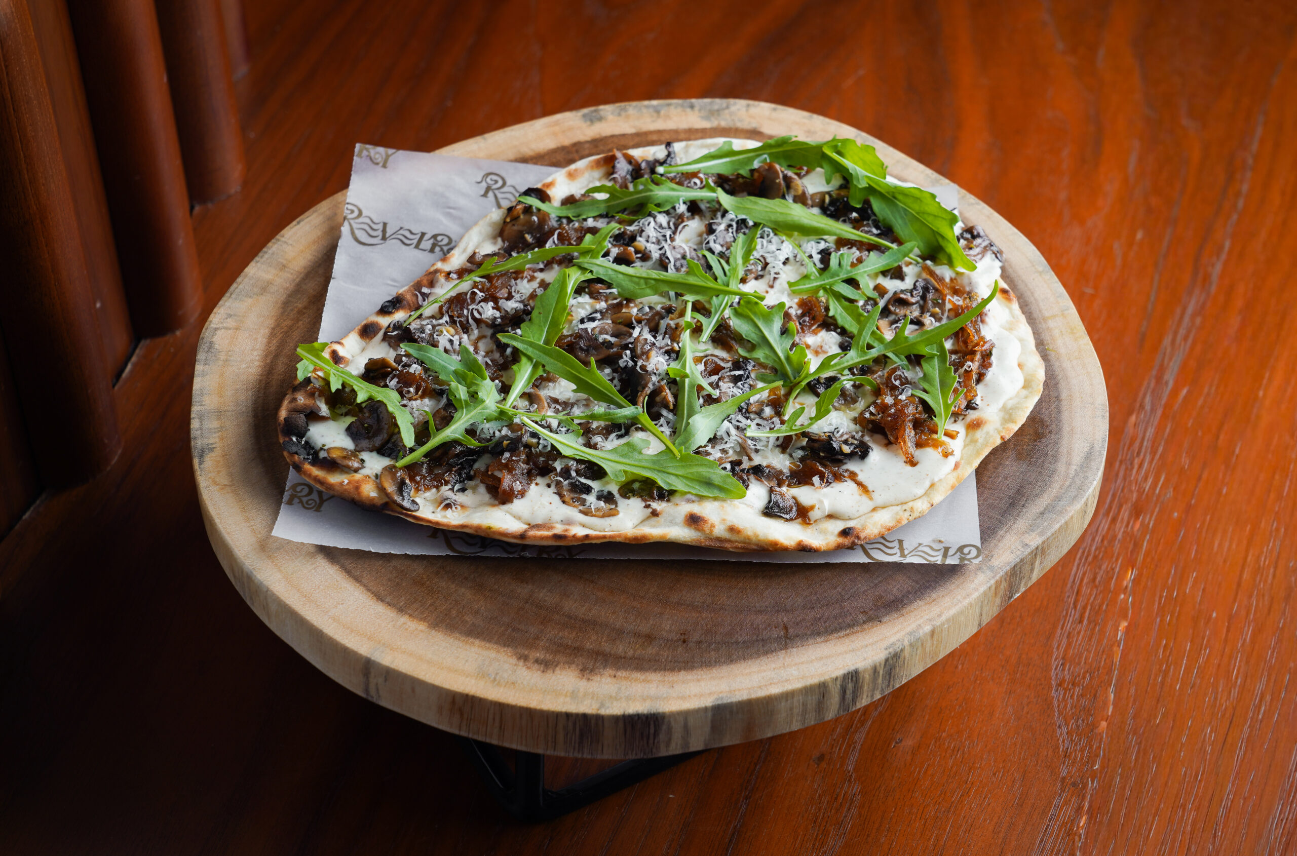 Naan-izza – Truffled Malai Kumbh, Caramelized Onion & Arugula